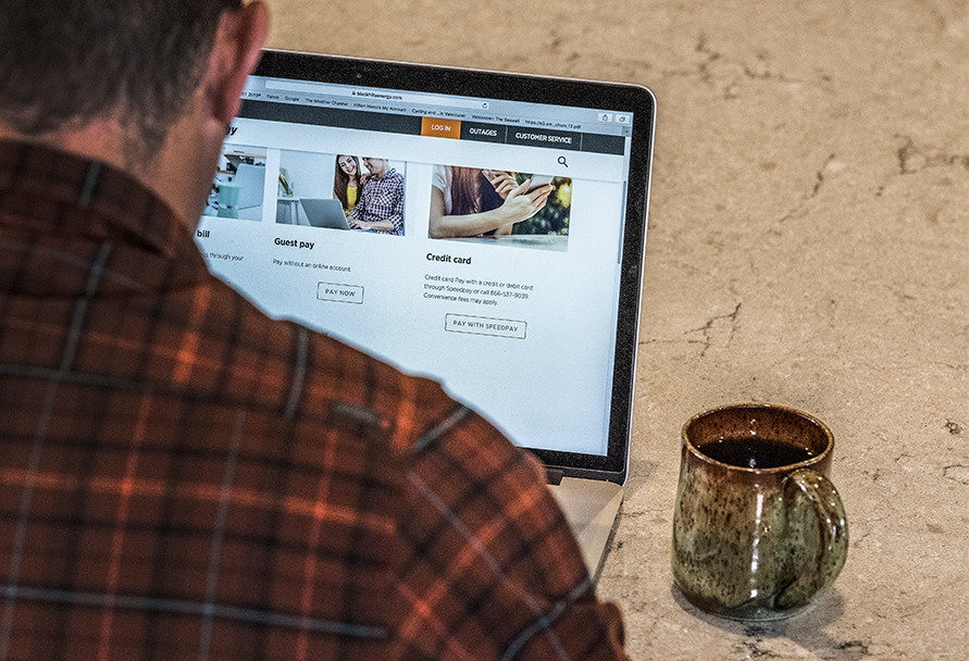 Man paying bill online with a laptop