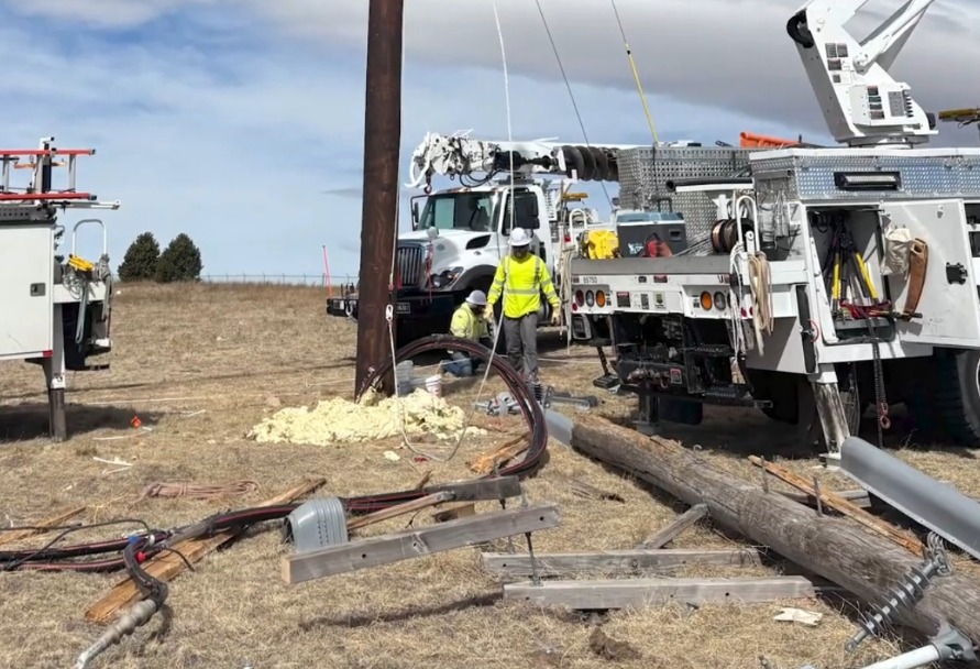 Linemen working to repair broken poles